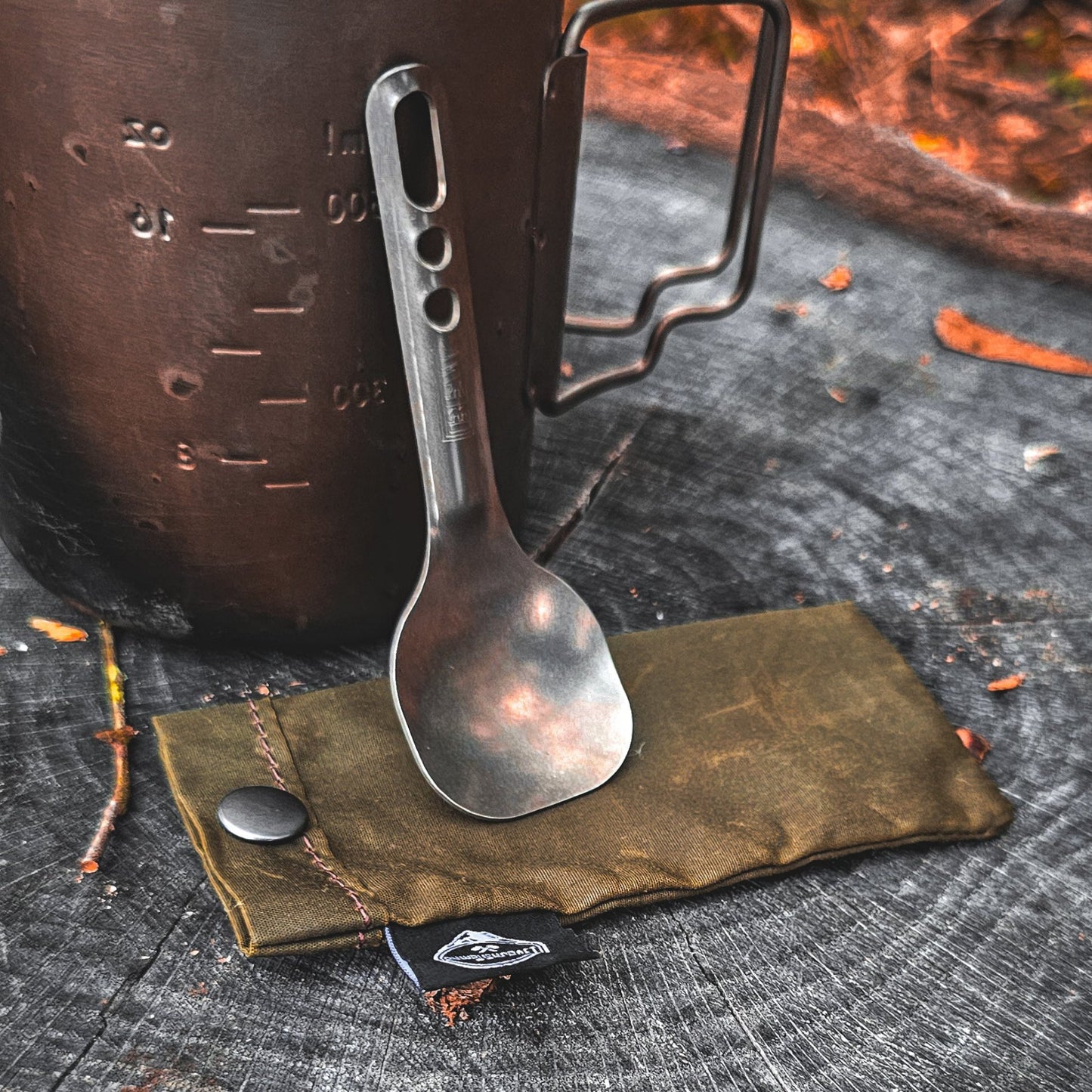 Waxed Canvas Tan Short Utensil Sleeve shown with stubby titanium spoon and cup