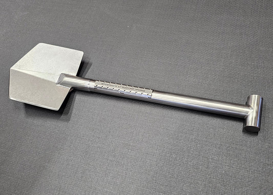 Titanium shovel with a handle on a gray background
