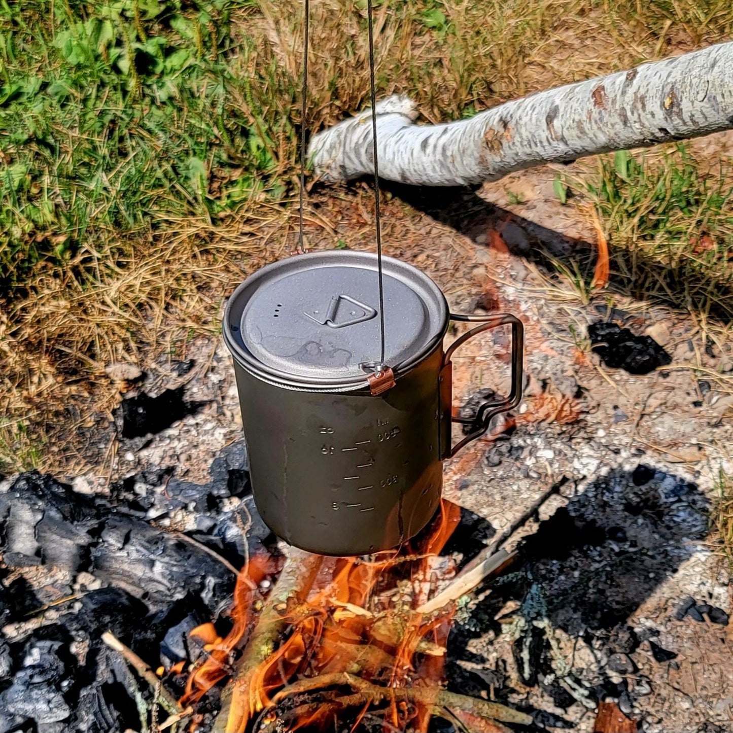 Brautigam Expedition Works Camp Snare uses titanium cup to cook over fire