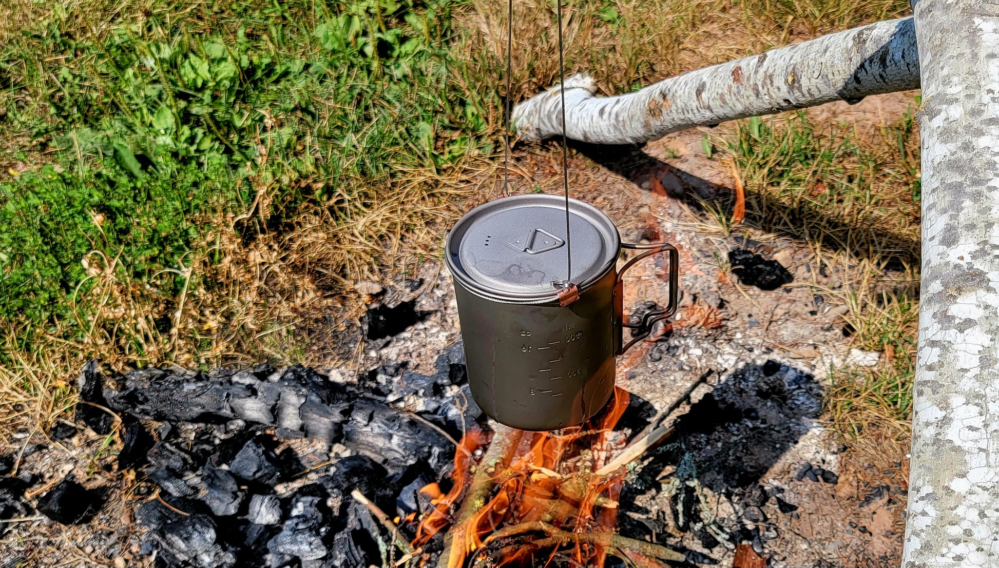 Brautigam Expedition Works Camp Snare uses titanium cup to cook over fire