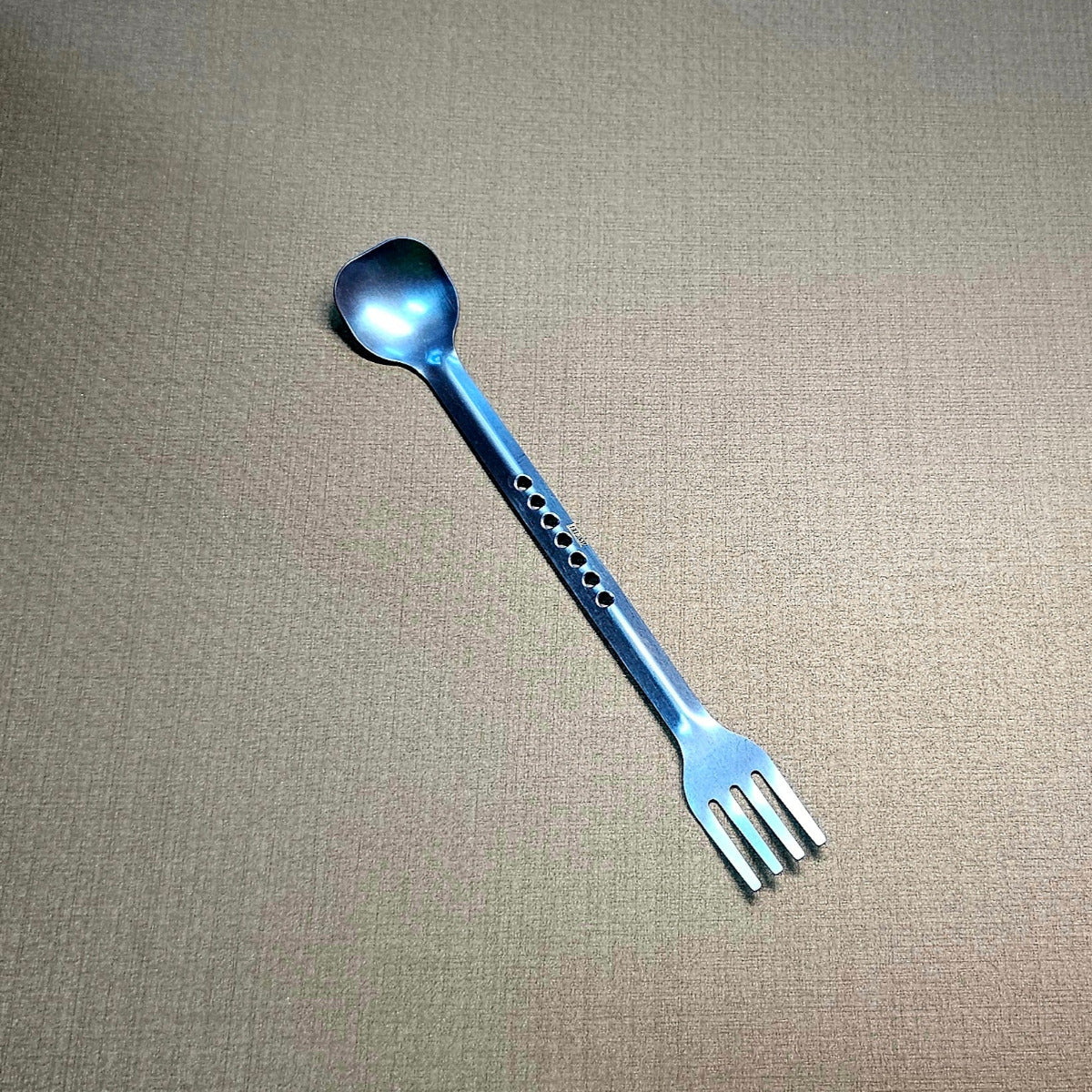 blue spoon with a unique design on a gray background