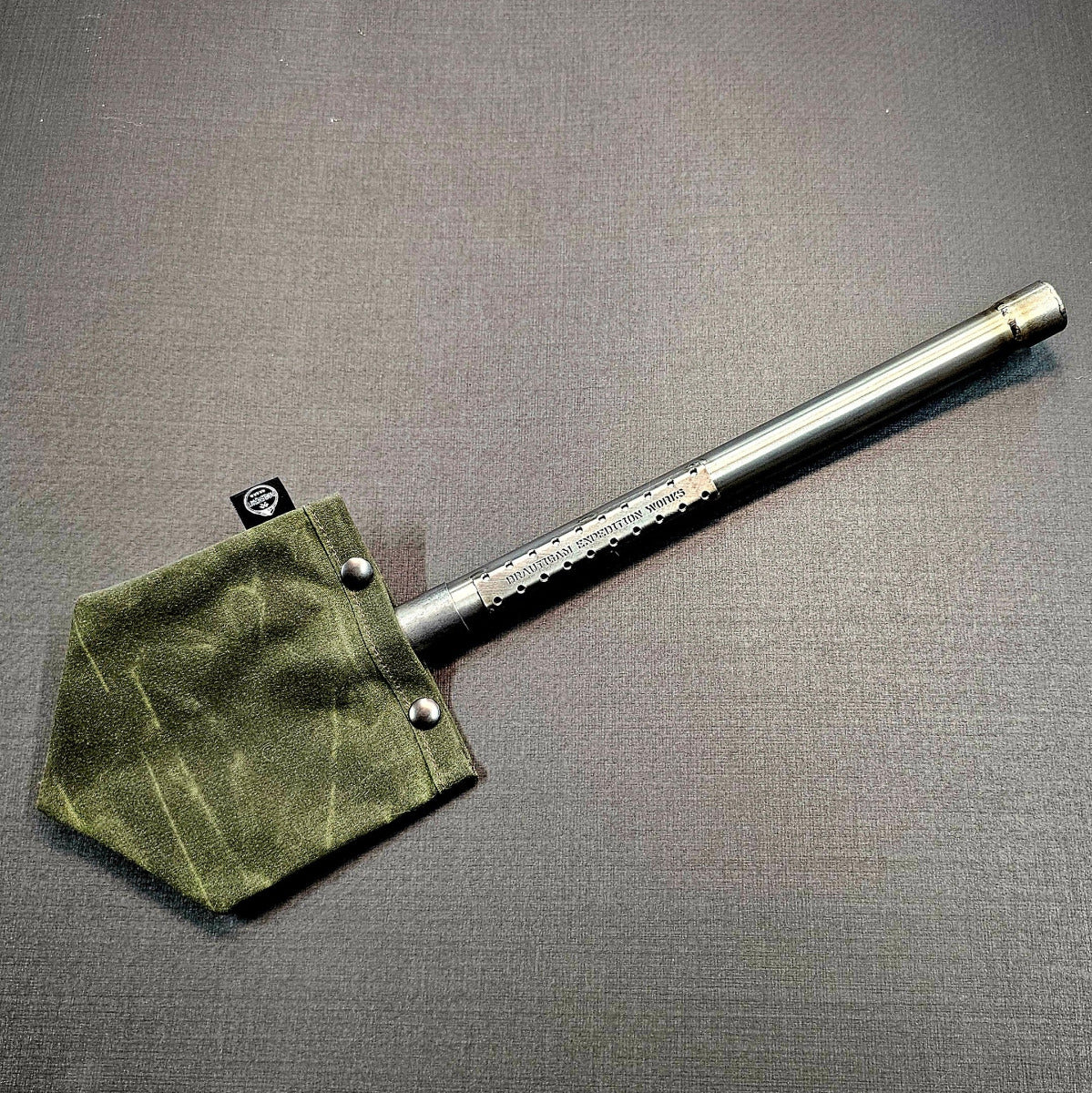 Green waxed canvas shovel cover with titanium shovel