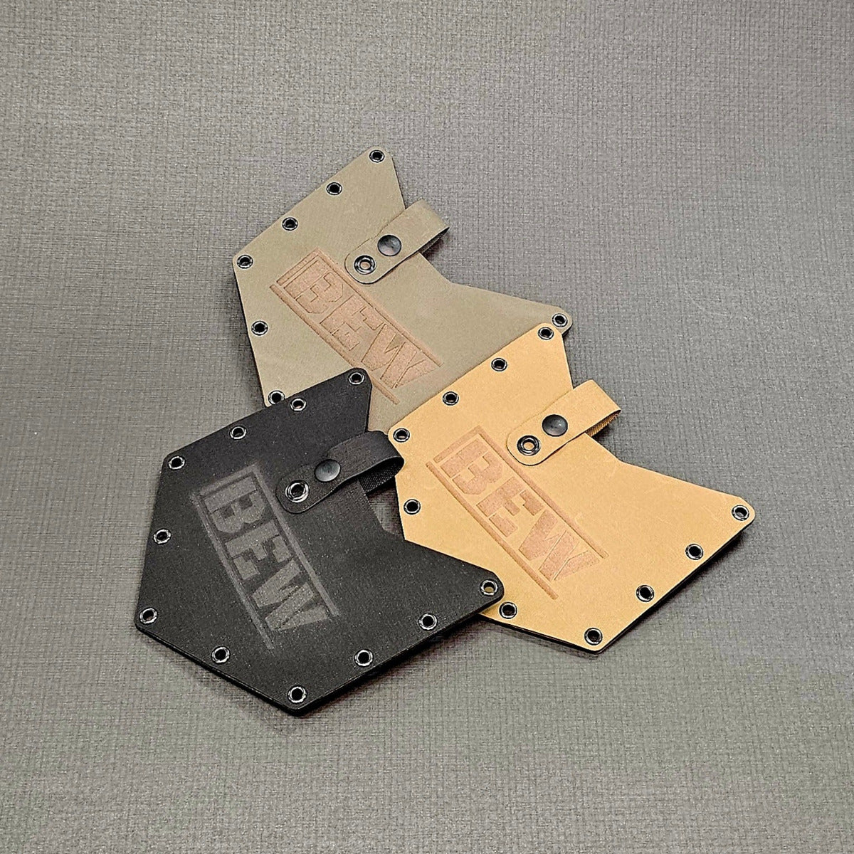 three shovel covers in black, brown and green.