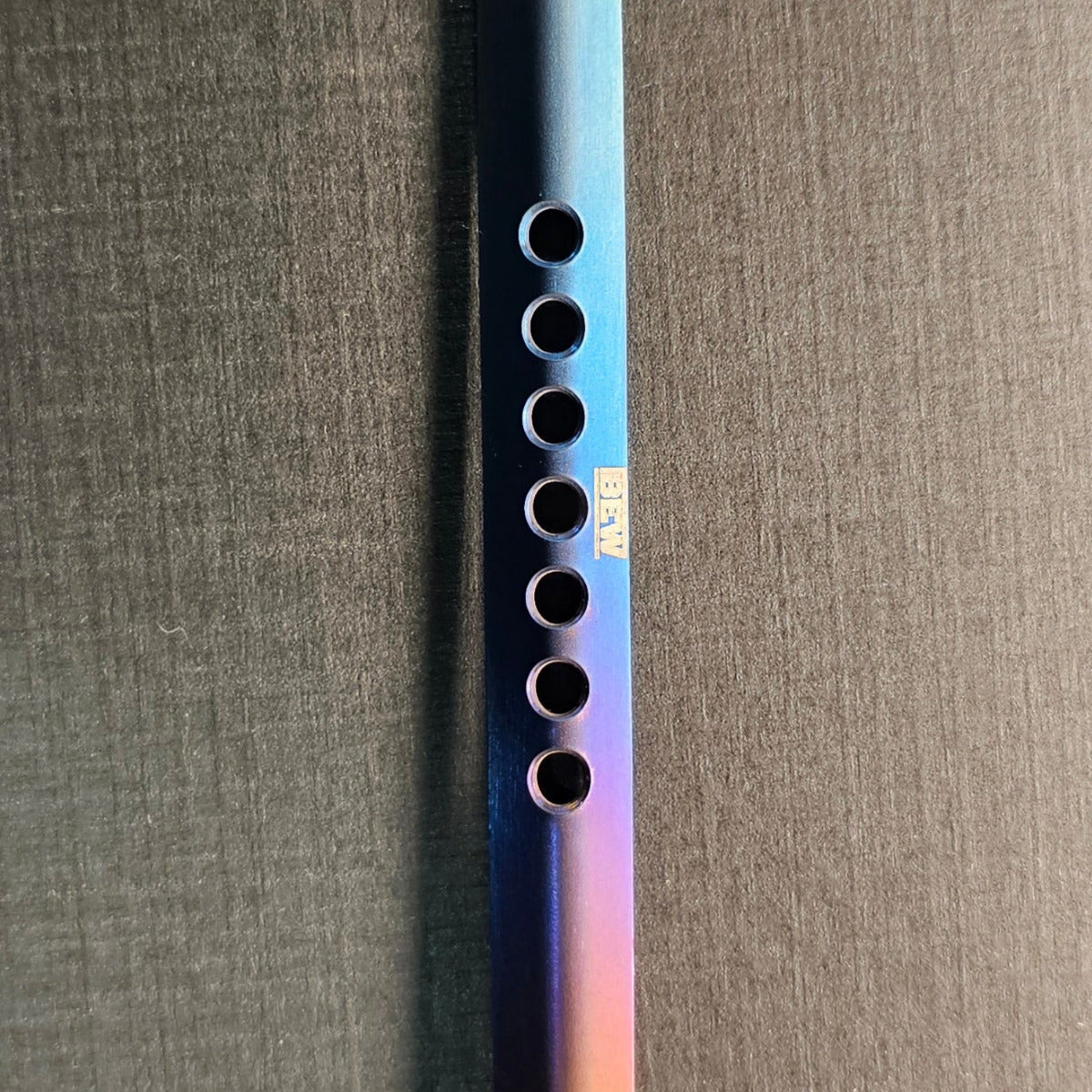 Multicolored spoon and fork on a dark surface